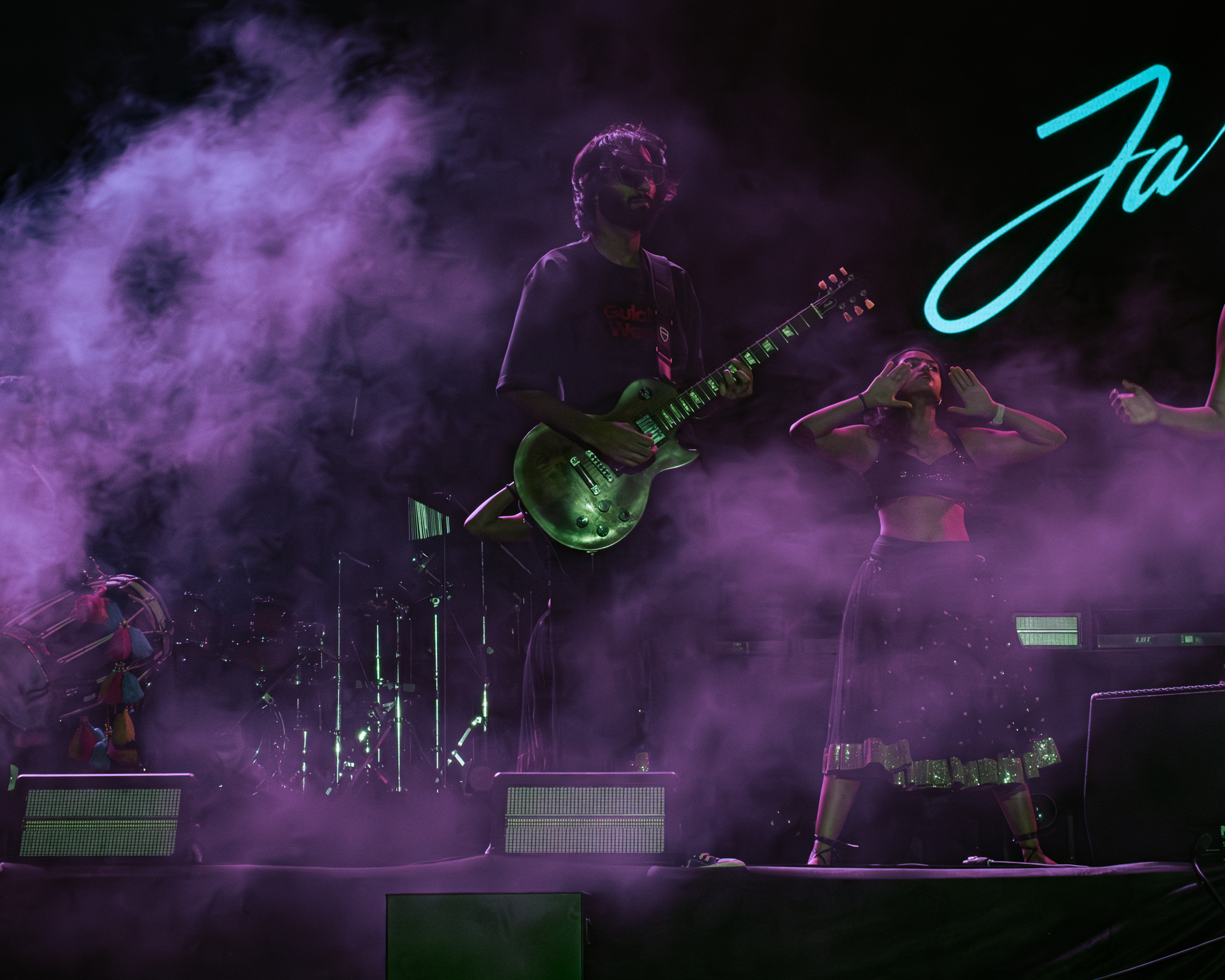 Guitarist and stage performer framed inside smoke